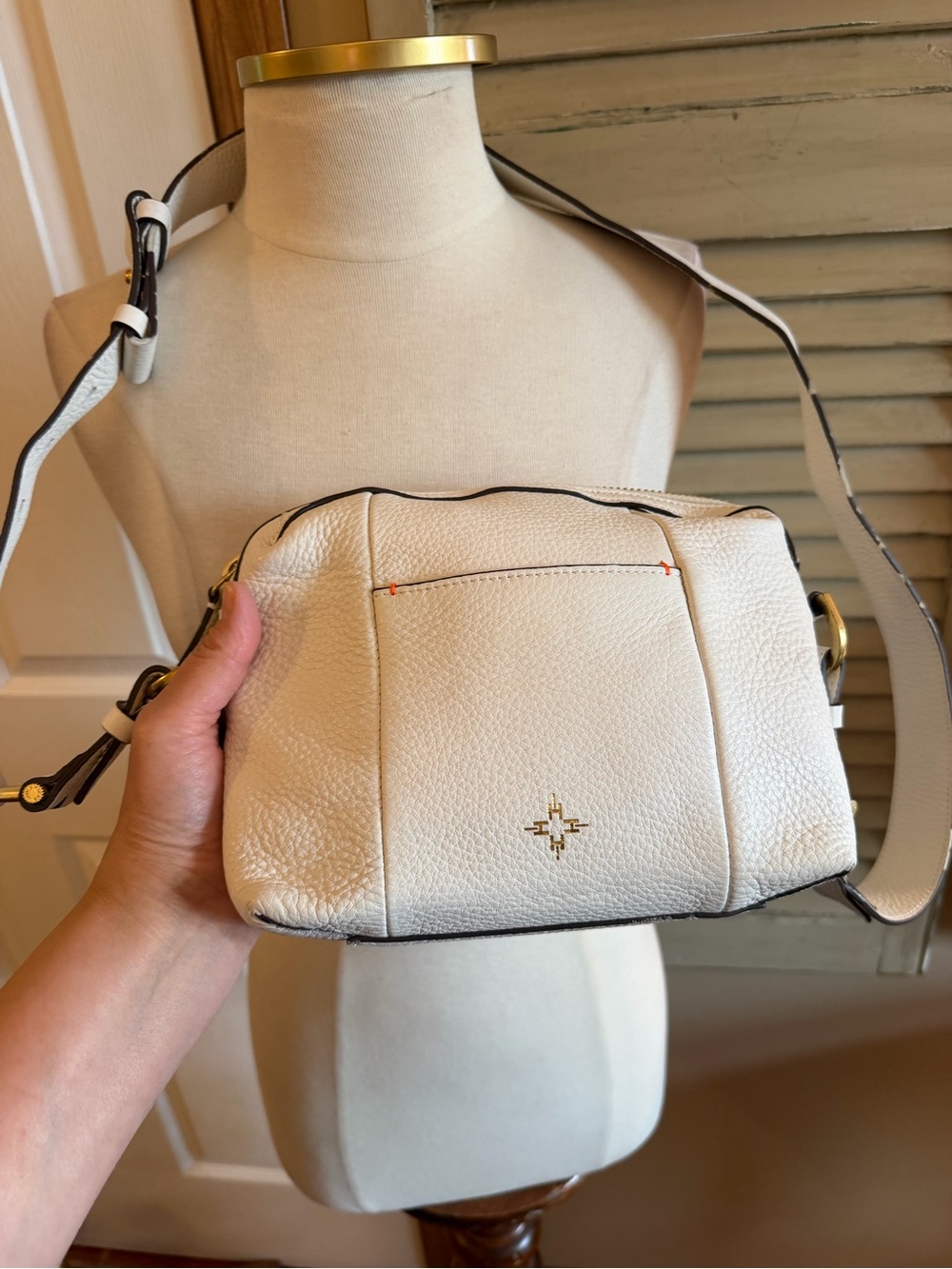 India Hicks Ivory Pebbled Leather Crossbody Bag with Gold Emblem